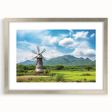 Framed wall art collection featuring a serene landscape with windmills, displayed in a sleek silver frame with a mat, ideal for home decor enhancement.