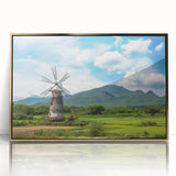Framed wall art featuring a picturesque landscape with iconic windmills, set against a vibrant sunset, accented by a gold frame for an elegant touch. Perfect for home decor.