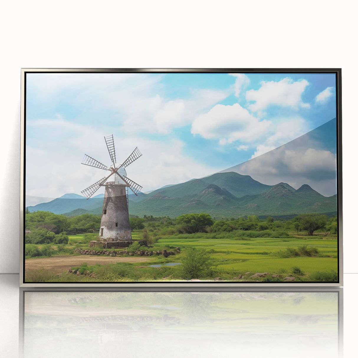 Framed wall art showcasing a picturesque landscape with windmills, featuring a silver-accented frame. Ideal for home decor, this piece combines elegance and tranquility.