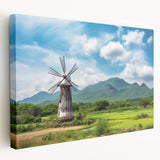 Stretched canvas wall art depicting a serene landscape with windmills, featuring vibrant colors and intricate details, perfect for home decor or office settings.