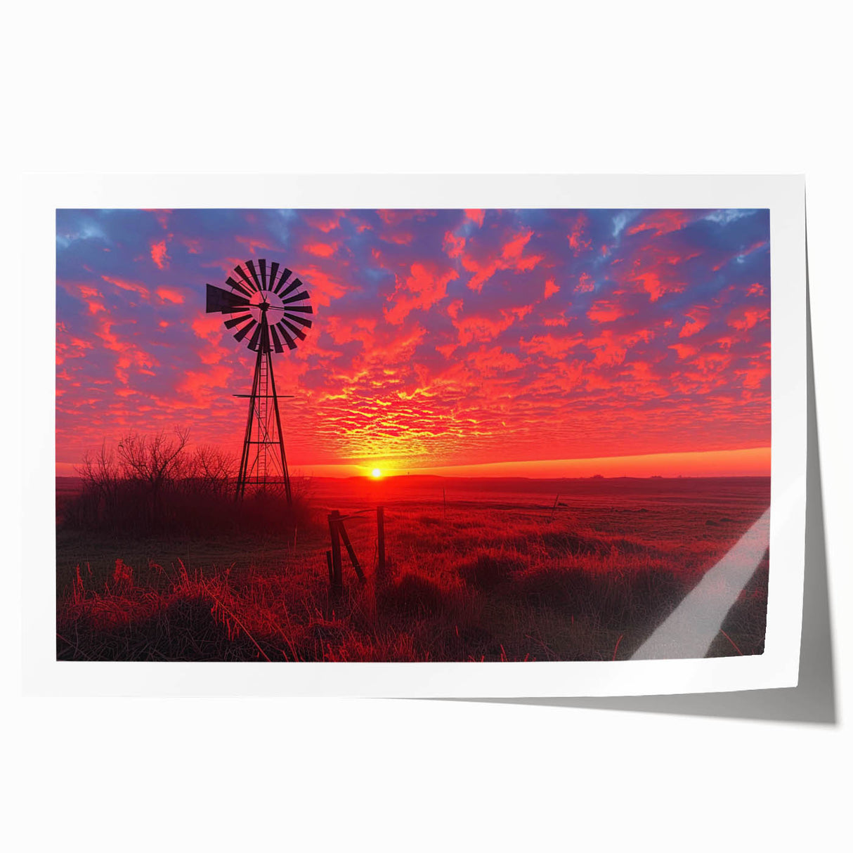 Rolled print showcasing a serene landscape with windmills at sunset, featuring vibrant colors and intricate details, perfect for home decor.
