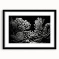 Framed wall art featuring a vibrant coral reef design with marine life, set in a sleek black frame and mat, ideal for ocean-themed decor.