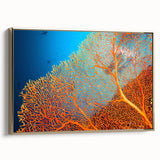 Framed canvas wall art featuring a vibrant coral reef design with intricate marine life details, accented with a stylish gold frame, ideal for ocean-themed decor.