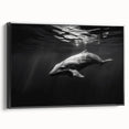 Framed canvas wall art featuring a vibrant dolphin design in shades of blue and green, set against a sleek black frame, perfect for marine life enthusiasts.