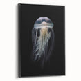 Framed canvas wall art showcasing a vibrant jellyfish design in shades of blue and purple, set against a sleek black frame, ideal for marine-themed decor.