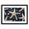 Black-framed wall art showcasing a vibrant starfish design, part of a marine life collection, presented with a white mat for an elegant finish.