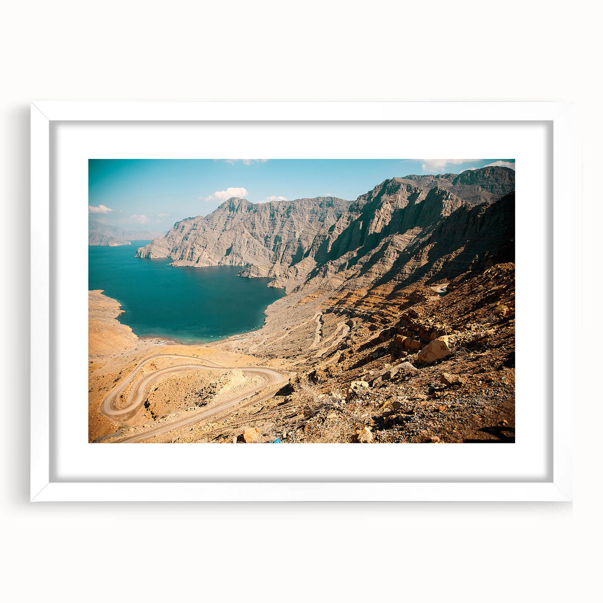 Abstract art print featuring swirling patterns in muted earth tones, framed with a white mat.