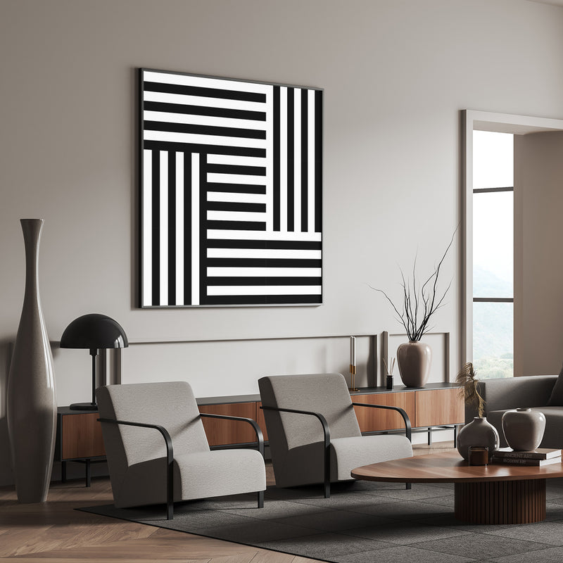 Modern black and white abstract wall art above a contemporary living room setup with clean lines