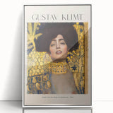 Art deco poster of a Gustav Klimt design in muted gold and black, acrylic print framed in white.