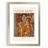 Textured abstract art print of swirling gold and blue patterns, framed in silver, suitable for bedroom decor.