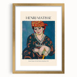 Textured abstract art print in vibrant red and blue tones on a gold-framed canvas, suitable for bedroom art.