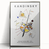 Mid-century modernist art featuring abstract shapes in vibrant primary colors on a silver-framed acrylic print.