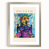 Textured abstract art print in vibrant red and blue, framed in silver, ideal for bedroom art.