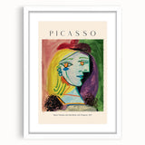 Abstract art print featuring geometric shapes in bold colors, framed in white, suitable for bedroom or dining room decor.