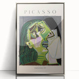 Mid-century modernist art depicting abstract forms in vibrant colors on a silver-framed acrylic print.