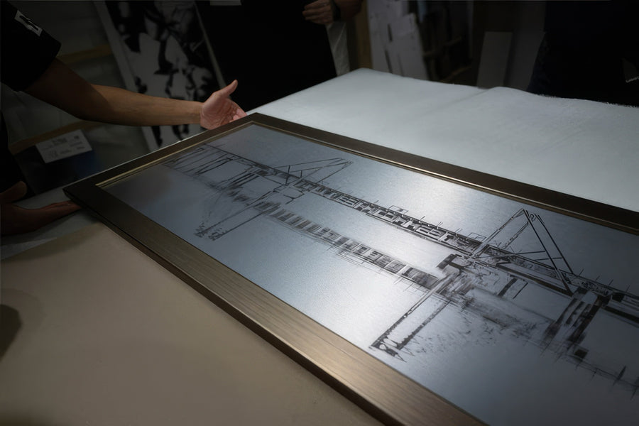 Brushed metal print being set into a frame