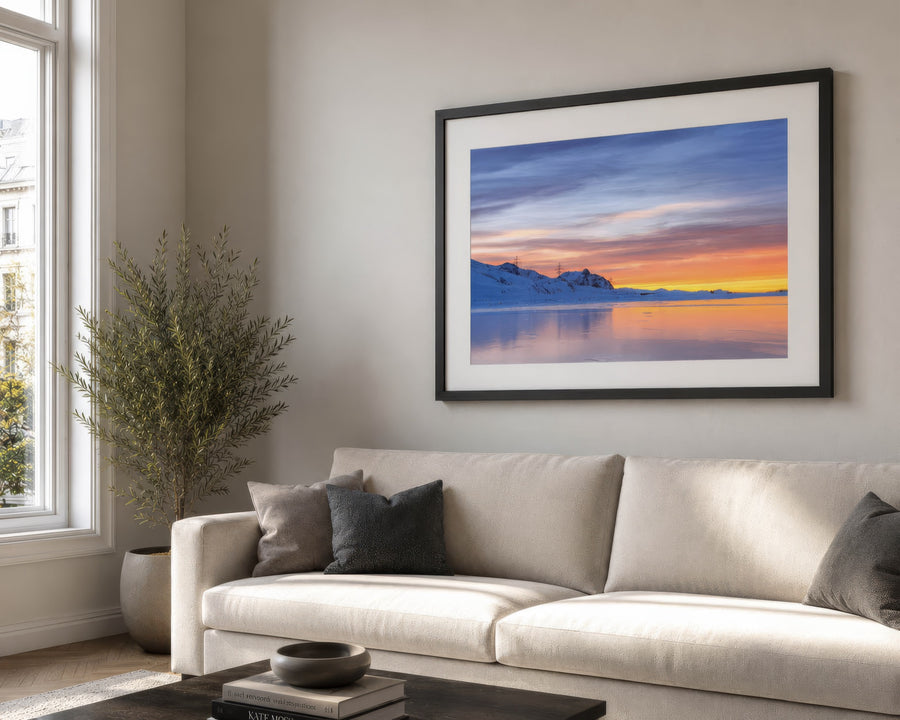 Framed print with a white mat above a living room sofa