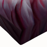 Close-up black and white photo of a bird on stretched canvas.