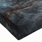 Close-up black and white photo of a bird on stretched canvas.