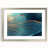 Textured art print of abstract birds in muted earth tones on a silver framed canvas, suitable for bedroom decor.