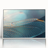 Art deco poster of birds in flight, using muted blue and green tones on a white acrylic framed material.