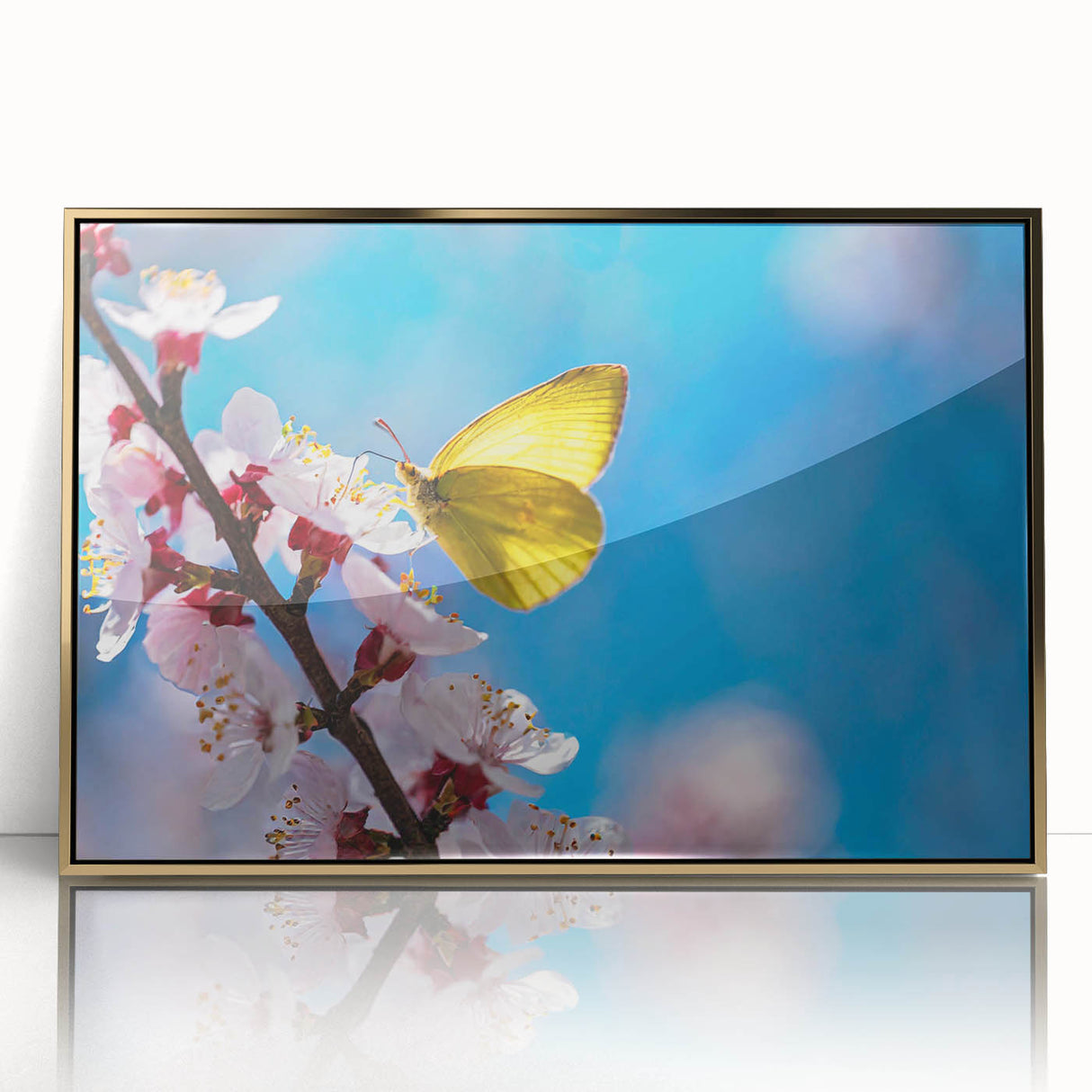 Large art print of a mid-century modernist bird design in muted gold tones on framed acrylic.