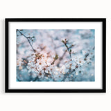 Abstract art print featuring vibrant, colorful florals on a textured canvas, framed in black, ideal for living room decor.