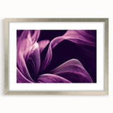 Textured art print of abstract florals in soft pink and green, framed in silver, suitable for bedroom decor.