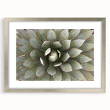 Textured art featuring abstract floral designs in soft pastel colors on a silver-framed mat, ideal for bedroom wall decor.