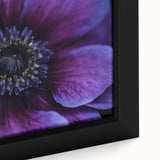 Close-up of a black framed canvas featuring a colorful, textured floral design, ideal for living room decor.