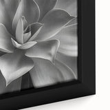 Close-up of a black wall art featuring colorful, textured flowers on a large framed canvas, ideal for living room decor.