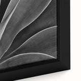 Close-up of black wall art featuring colorful, textured florals on a framed canvas, ideal for living room decor.