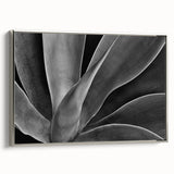 Framed canvas of a vintage-style landscape painting featuring colorful florals against a black background.