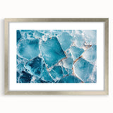 Abstract art print featuring a close-up frost design in cool blue and white tones, framed in silver.