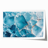 Close-up image of frost patterns on ice in muted blue tones, rolled print.