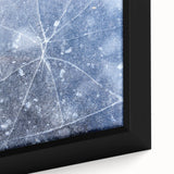 Close-up of textured black wall art depicting ice formations in vibrant blues and whites on a large framed canvas.