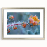 Abstract art print featuring detailed frost patterns in cool blue and white tones, framed in silver.