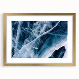 Textured art depicting abstract frost designs in muted blue and white tones, framed in gold, ideal for bedroom wall decor.