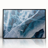 Large abstract wall art depicting frost patterns in muted grays and whites, framed in black acrylic.