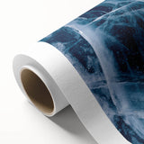 Art deco poster featuring a close-up of frost patterns in shades of white and blue on rolled canvas.