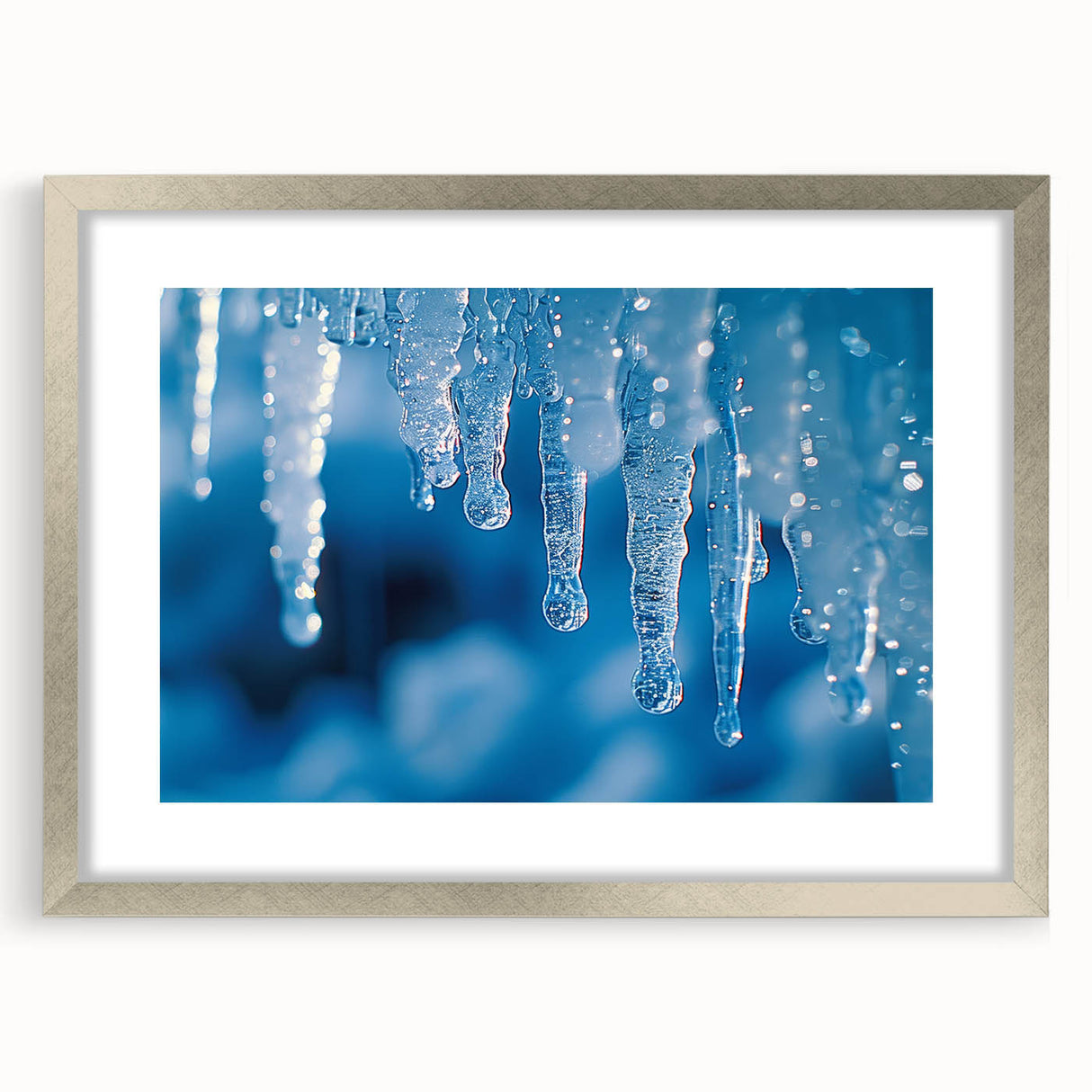 Abstract art print of frost patterns in cool blue and white tones, framed with a silver mat.