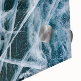 Close-up of frost pattern in muted blue and white on acrylic glass.