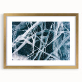 Textured art depicting abstract frost patterns in muted gray, framed in gold, ideal for bedroom art.