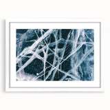 Extra large abstract art print depicting a frost-like texture in cool blue and white tones, framed with a white mat.