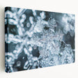 Close-up image of frost patterns on ice in muted blue and white tones on a large stretched canvas.