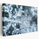 Close-up image of frost patterns on ice in muted blue and white tones on a large stretched canvas.