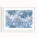 Abstract art print of a frost design in muted blue and white tones, framed with a white mat, suitable for dining room decor.