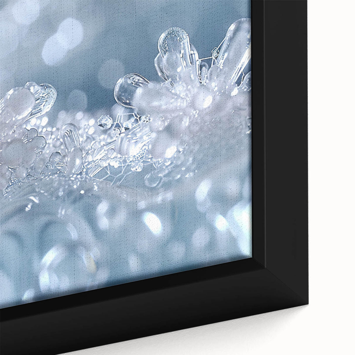 Close-up of textured ice patterns on a black framed canvas, featuring vibrant, colorful art.