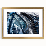 Textured art print of abstract frost patterns in muted gray tones, framed in gold, suitable for bedroom decor.