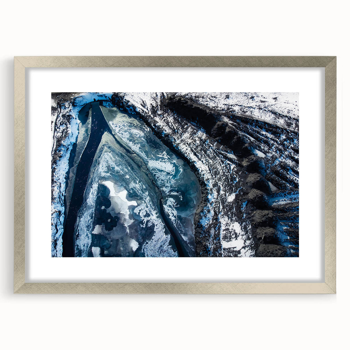 Abstract art print of frost patterns in muted white and gray tones, framed with a silver mat, ideal for dining room decor.